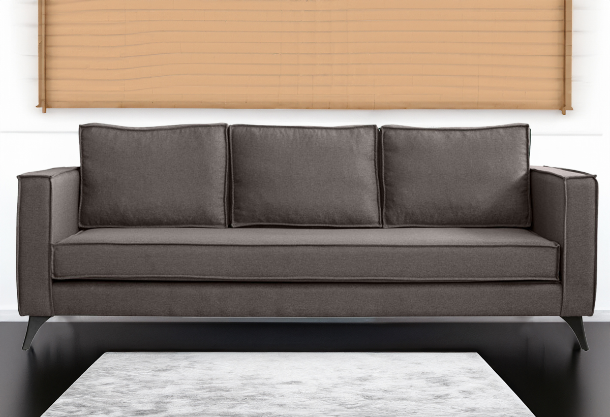 Απεικονίζεται ο καφέ καναπές τοποθετημένος σε σαλόνι ενώ μπροστά υπάρχει μία μοκέτα.